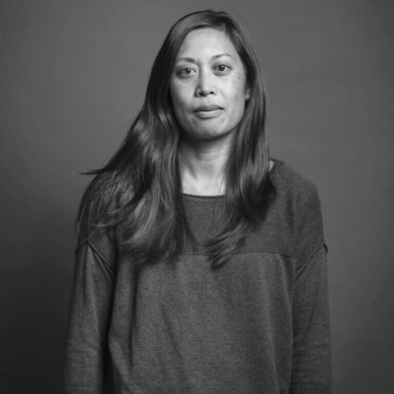 10 Bernice Yeung-photo-B_W-1046x1140 Black and white photo of Bernice Yeung with her arms at her sides, facing the camera.