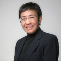 Headshot of Maria Ressa, she is wearing a black blazer over a black shirt and smiling.